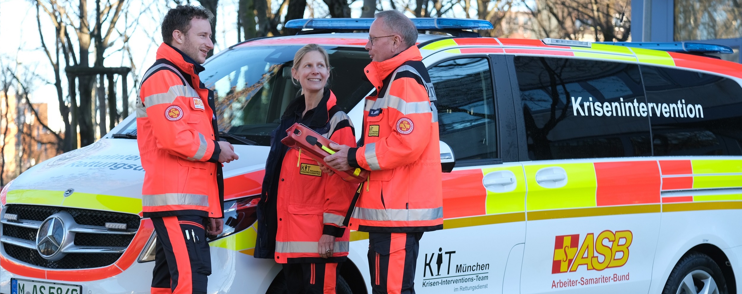 Drei KIT Einsatzkräfte im Gespräch vor dem KIT-Einsatzfahrzeug